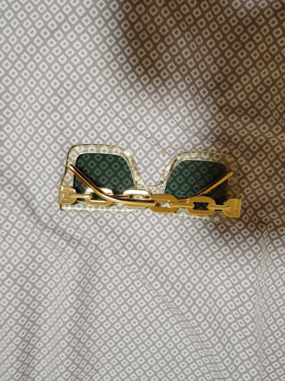 Clear Frame Sunglasses with Gold Chain Arms and Green Lenses